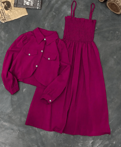 Magenta sleeveless smocked dress with matching long sleeve button-up shirt on gray background