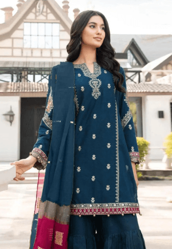 Woman wearing blue embroidered traditional ethnic suit with dupatta, outdoor fashion