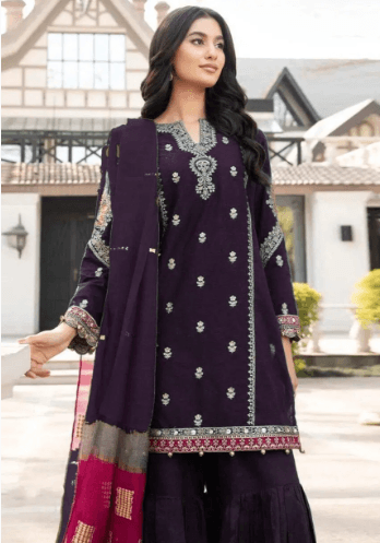 Woman wearing embroidered purple traditional suit with dupatta outdoors