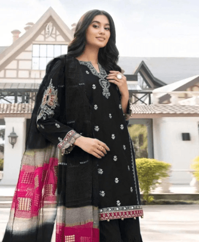 Woman wearing black embroidered ethnic dress with colorful dupatta, outdoor setting
