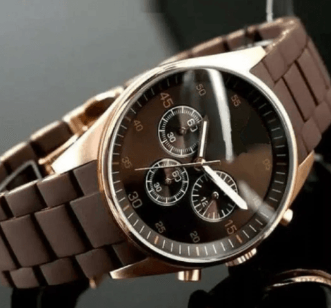 Men's luxury brown analog wristwatch with chronograph subdials and gold case on display
