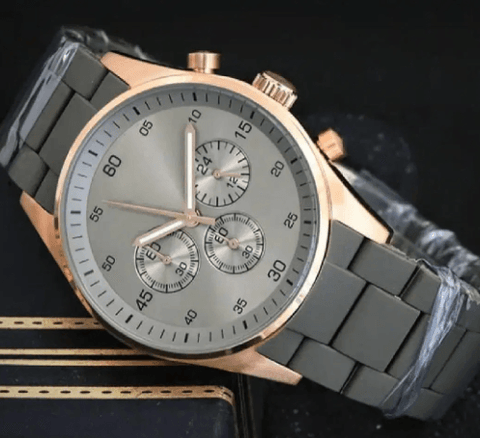 Luxury men's wristwatch with gray metal band, rose gold case, and chronograph dial
