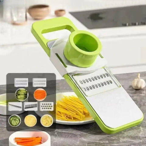 Multi-blade vegetable slicer and grater with green handle on kitchen counter