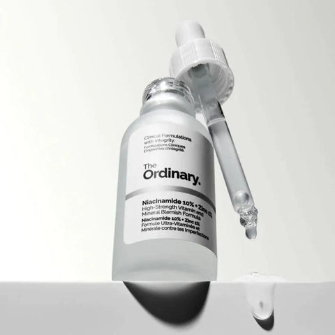 The Ordinary Niacinamide 10% + Zinc 1% serum bottle with dropper and clear liquid drop