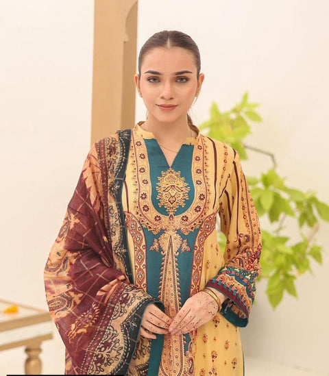 Woman in yellow and teal traditional printed kurta with matching dupatta, indoor setting