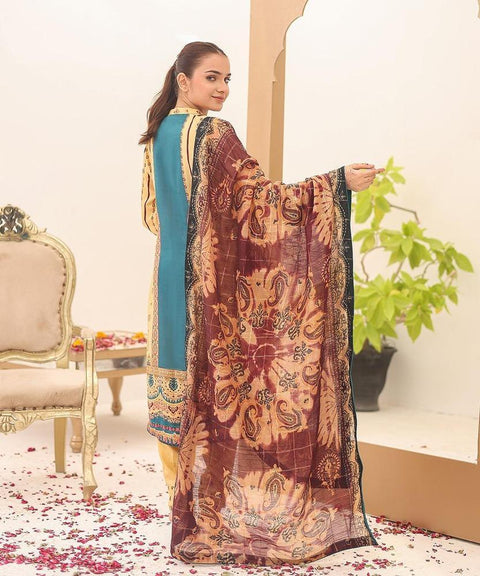 Woman wearing embroidered teal and yellow ethnic suit with printed brown dupatta indoors
