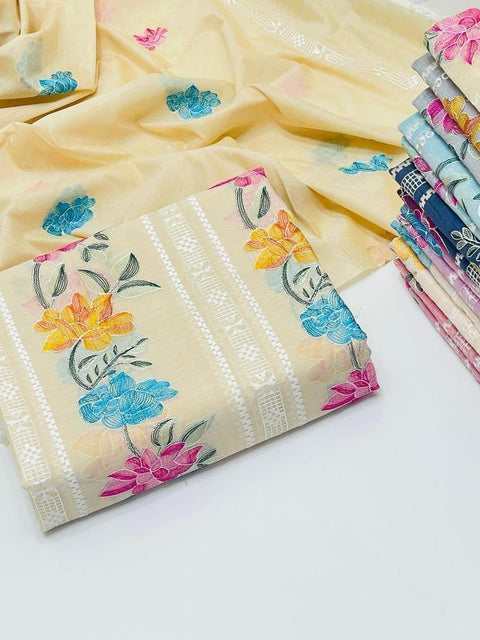 Beige floral embroidered fabric with colorful flowers, stacked textile fabrics in background
